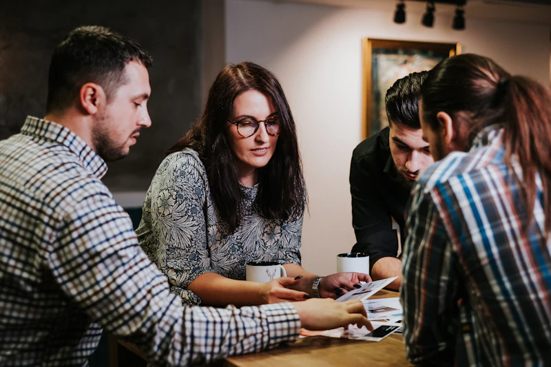 Colleagues discussing documents at a table